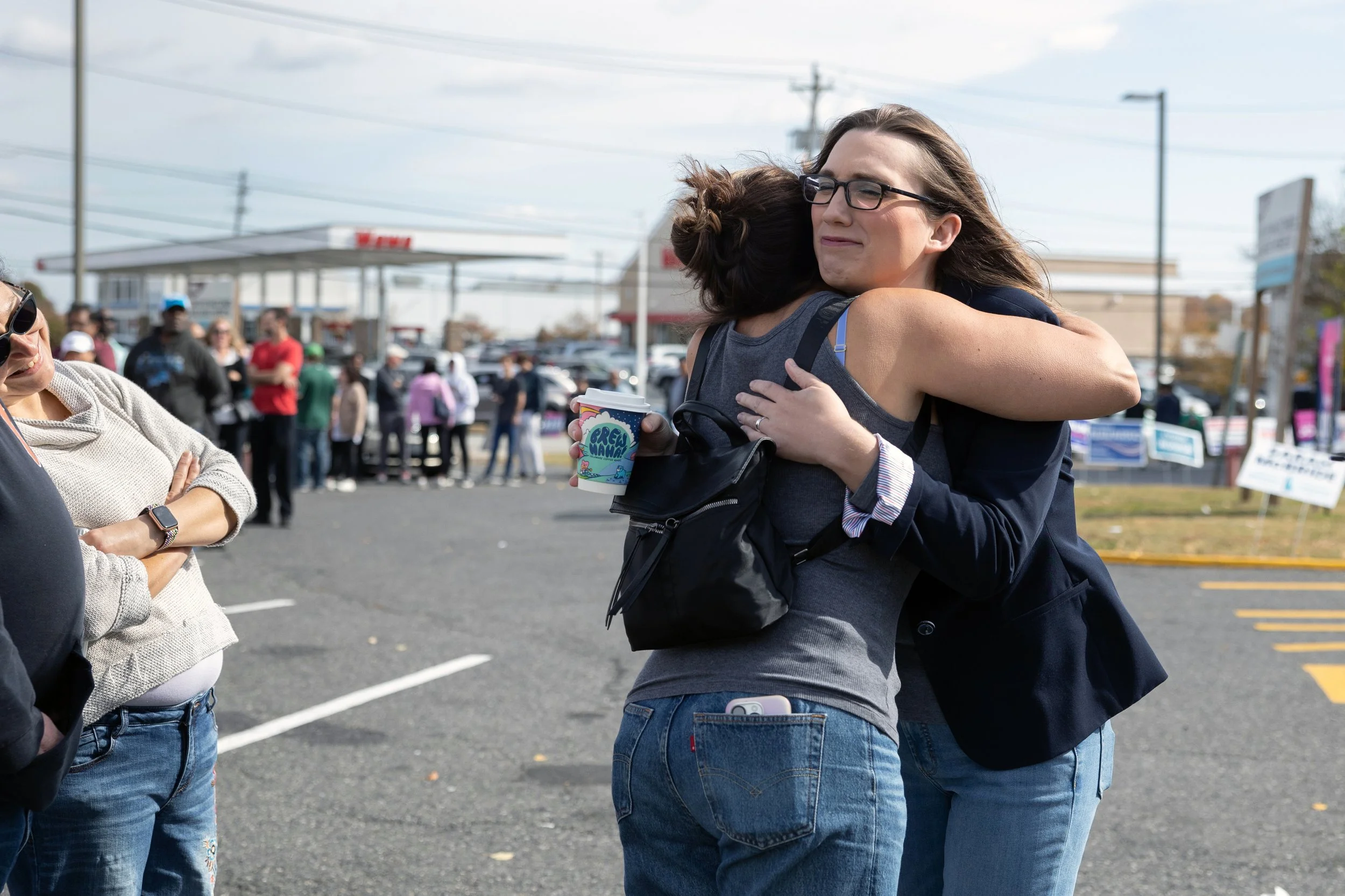  Sarah McBride (right), Delaware state senator and the first transgender  United States Representative, speaks to voters outside of any early voting location in Newark, Delaware on October 26, 2024. (On assignment for Reuters) 