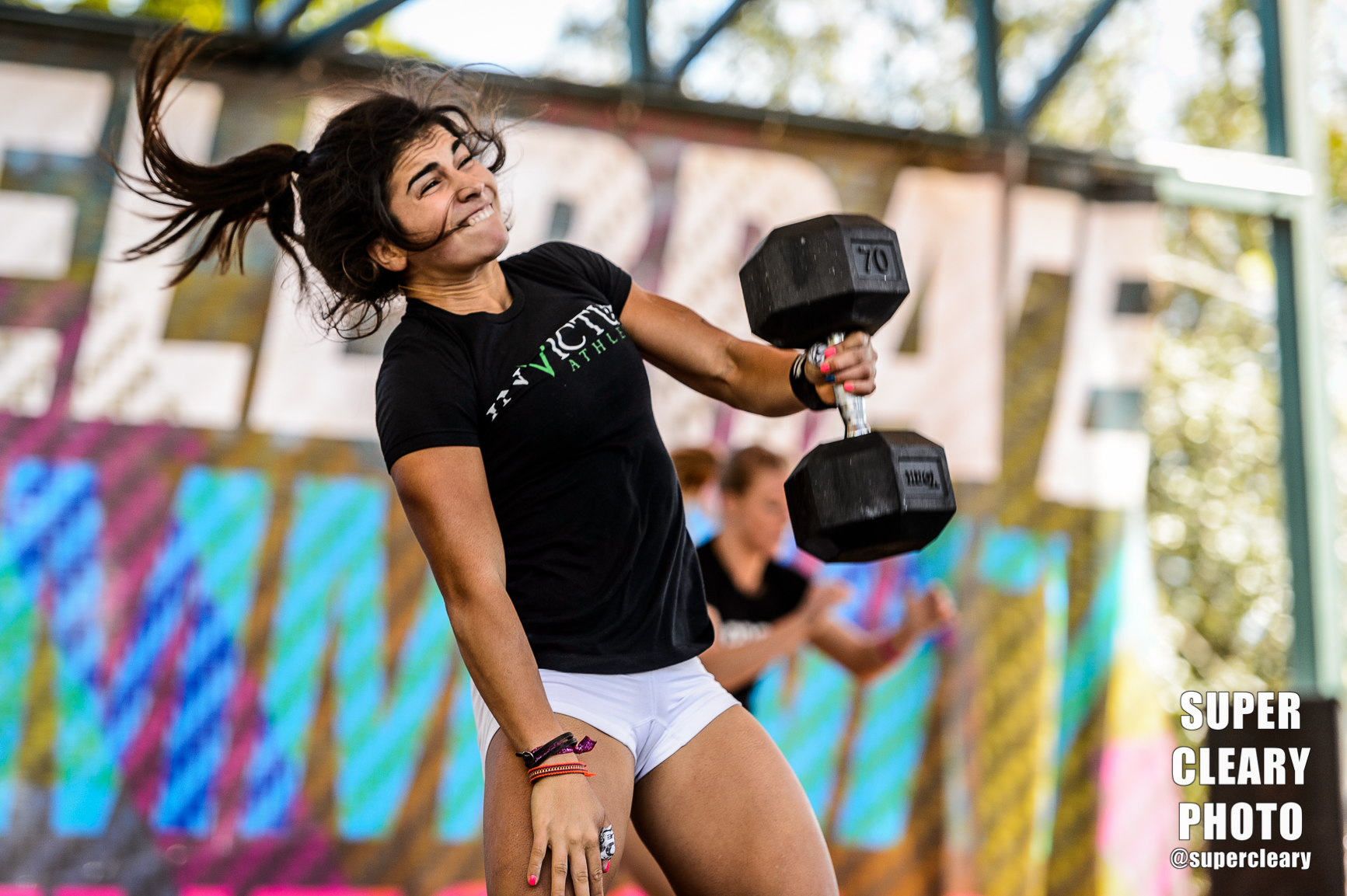 Lauren Fisher during the dumb bell snatch workout -- Nikon D4, Nikon 70-200, 1/640th, F2.8, ISO 320 -- notice my shutter started slowing. The stage had a crazy split light scenario that gradually got brighter as they got farther from the back of the stage. On the fly I just adjusted my shutter speed as she got into the brighter light. 