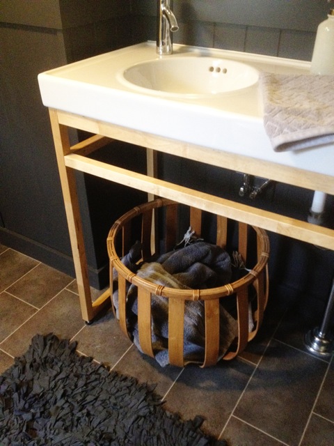  ​IKEA MOLGER vanity and a ribbon basket from West Elm 