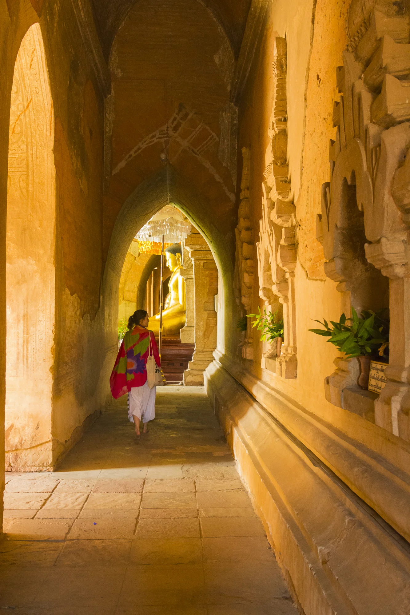 Woman walking through a temple, Bagan, Mandalay.