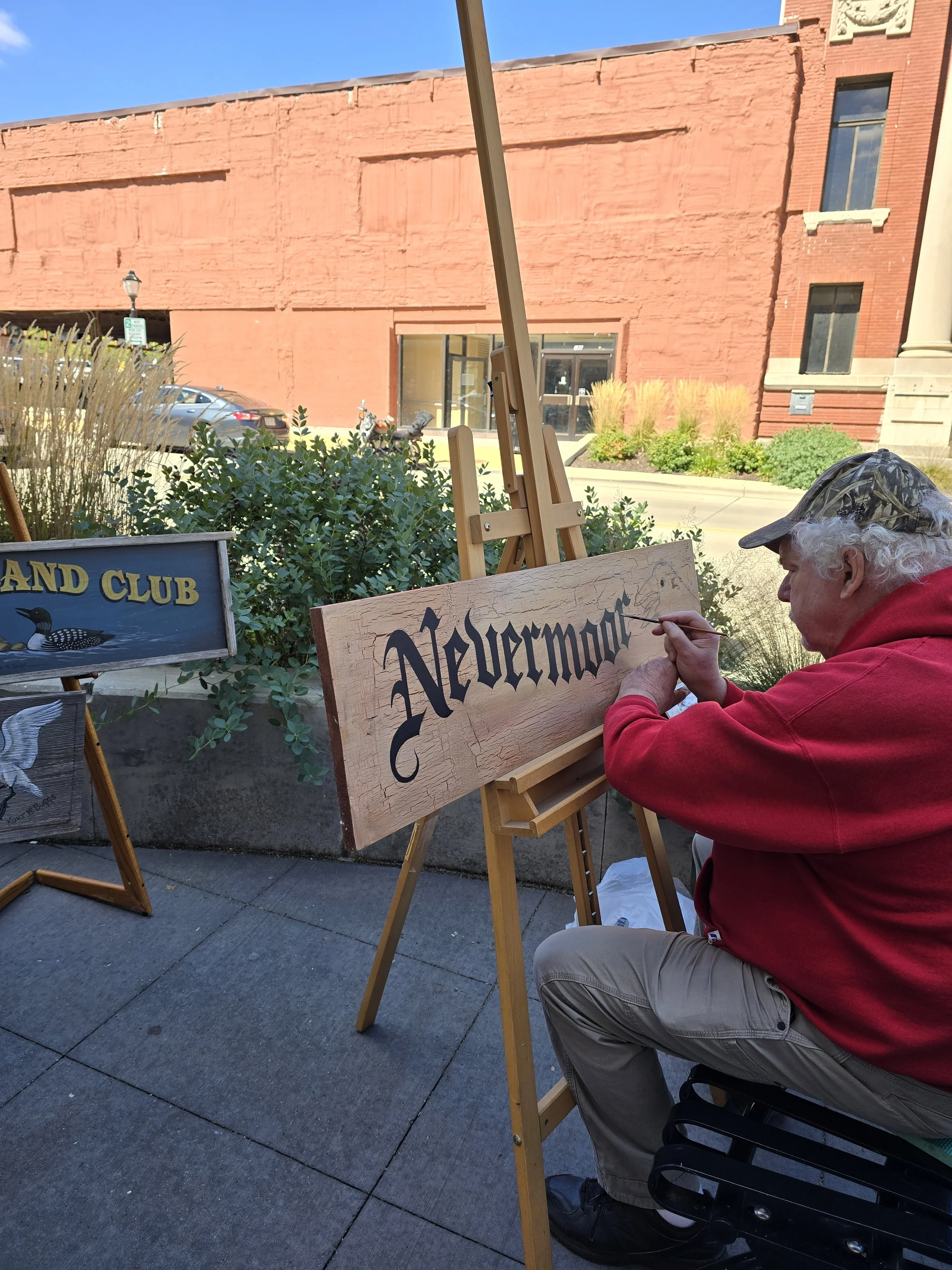 Kurt Buggs painting a sign in downtown Janesville, WI