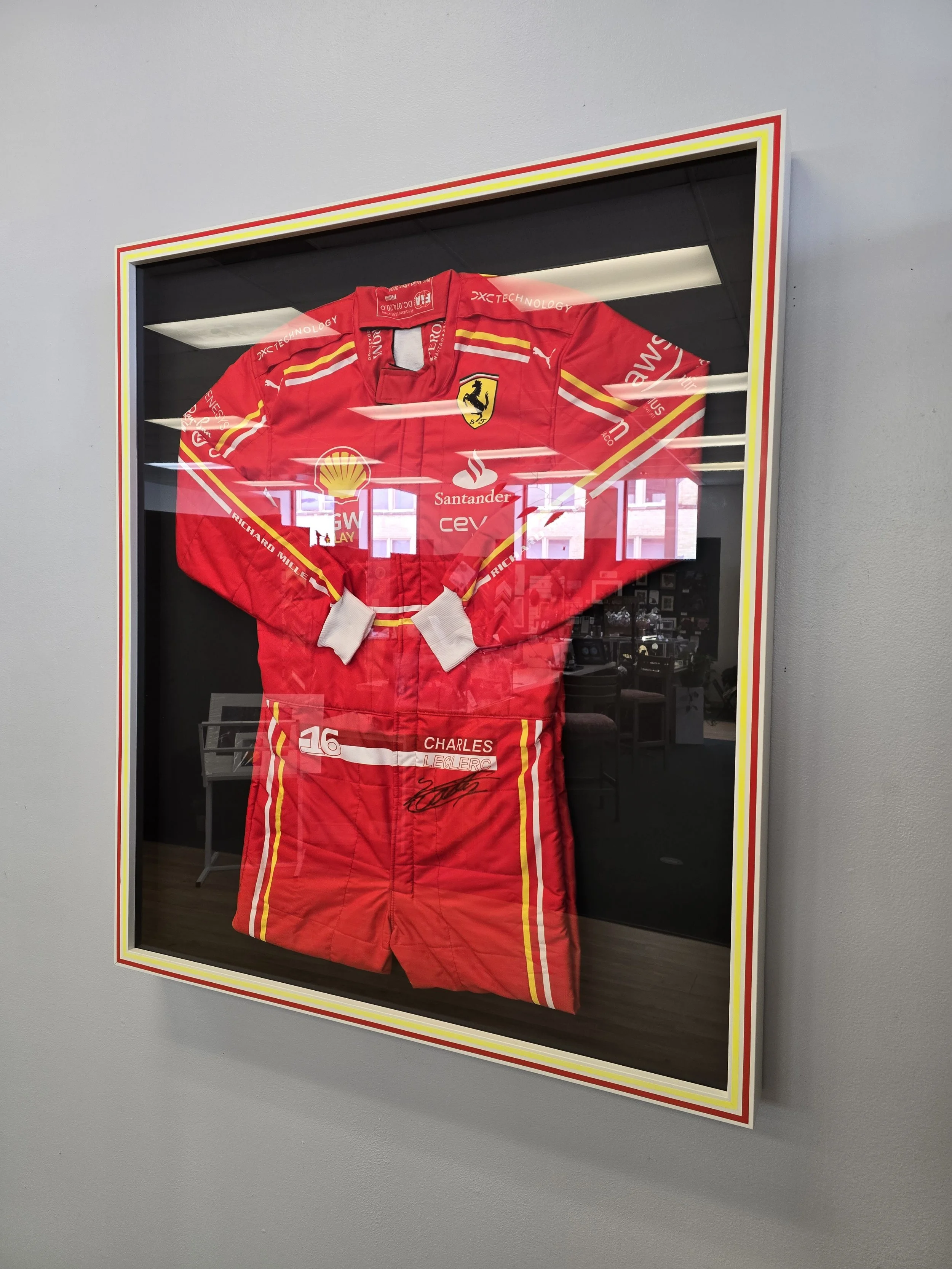 Framed F1 fire suit, signed by Charles Leclerc