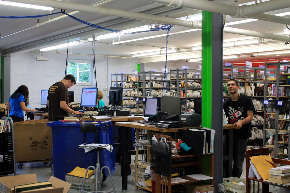 Volunteer sort and scan books at More Than Words, a TUGG portfolio graduate