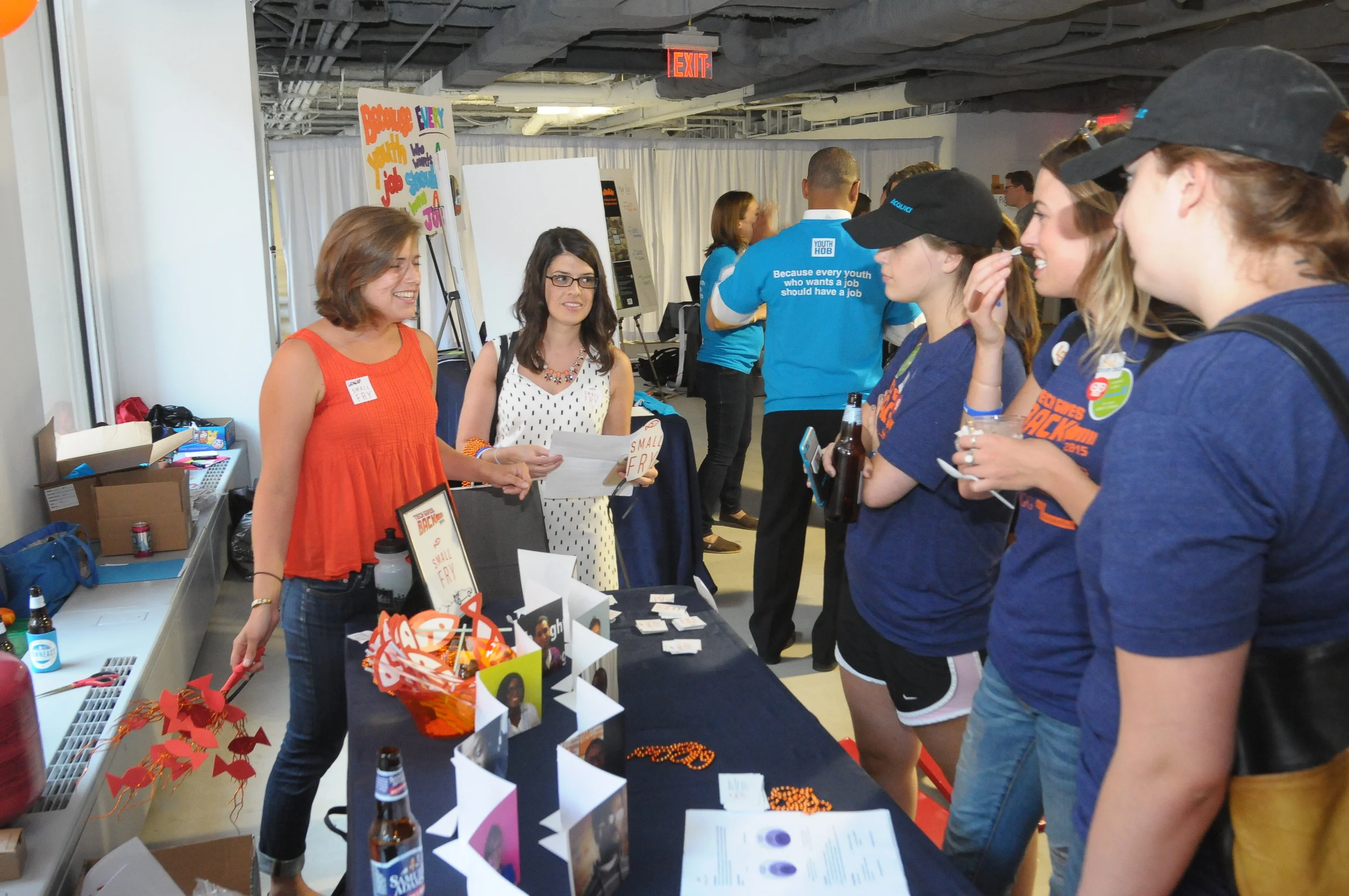 Small Fry volunteers educating TUGGers on their model to provide jobs to local youth