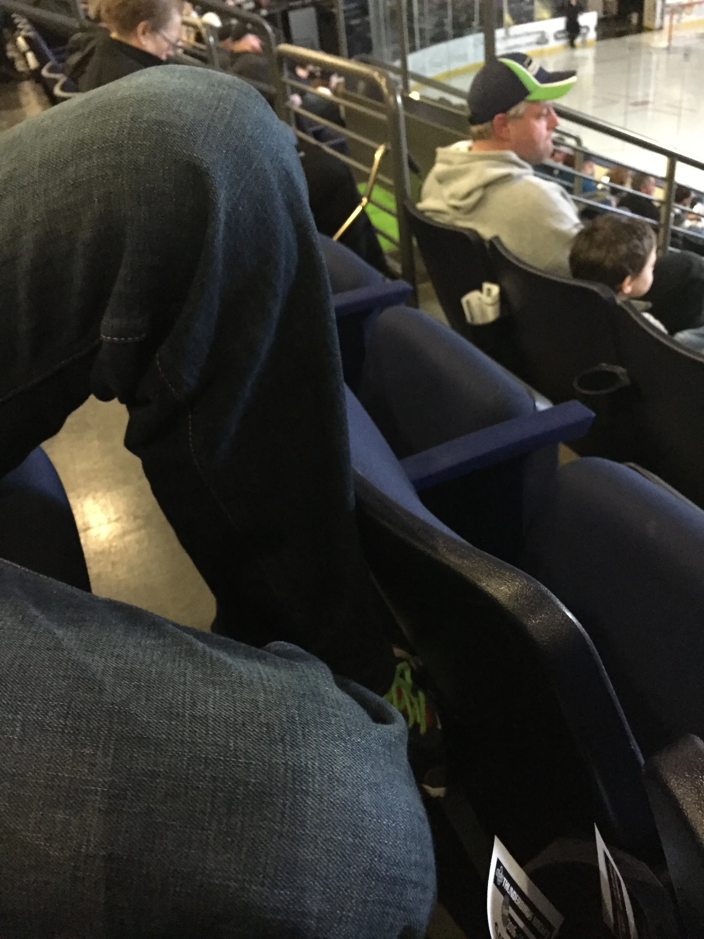 Chris's poor legs. No room at the hockey game for six foot boys and their long legs!