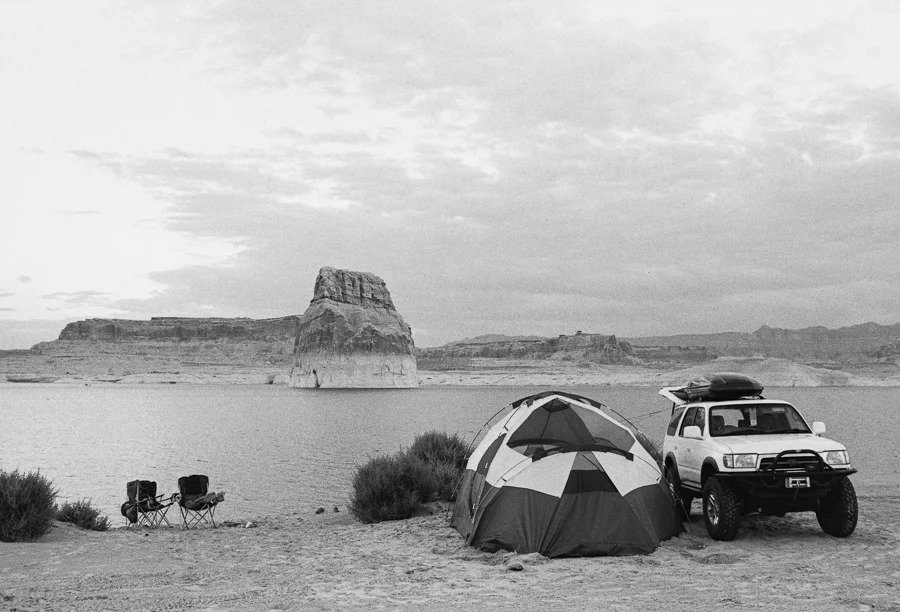 ^ After a day that started with breaking camp in a downpour, then the following monsoon enduring drive, we finally arrived back to Lone Rock Beach at Lake Powell. We pulled the rig right up to the sandy shoreline and pitched camp in the blissfully dry desert air which quickly dried out all of our soaked gear.