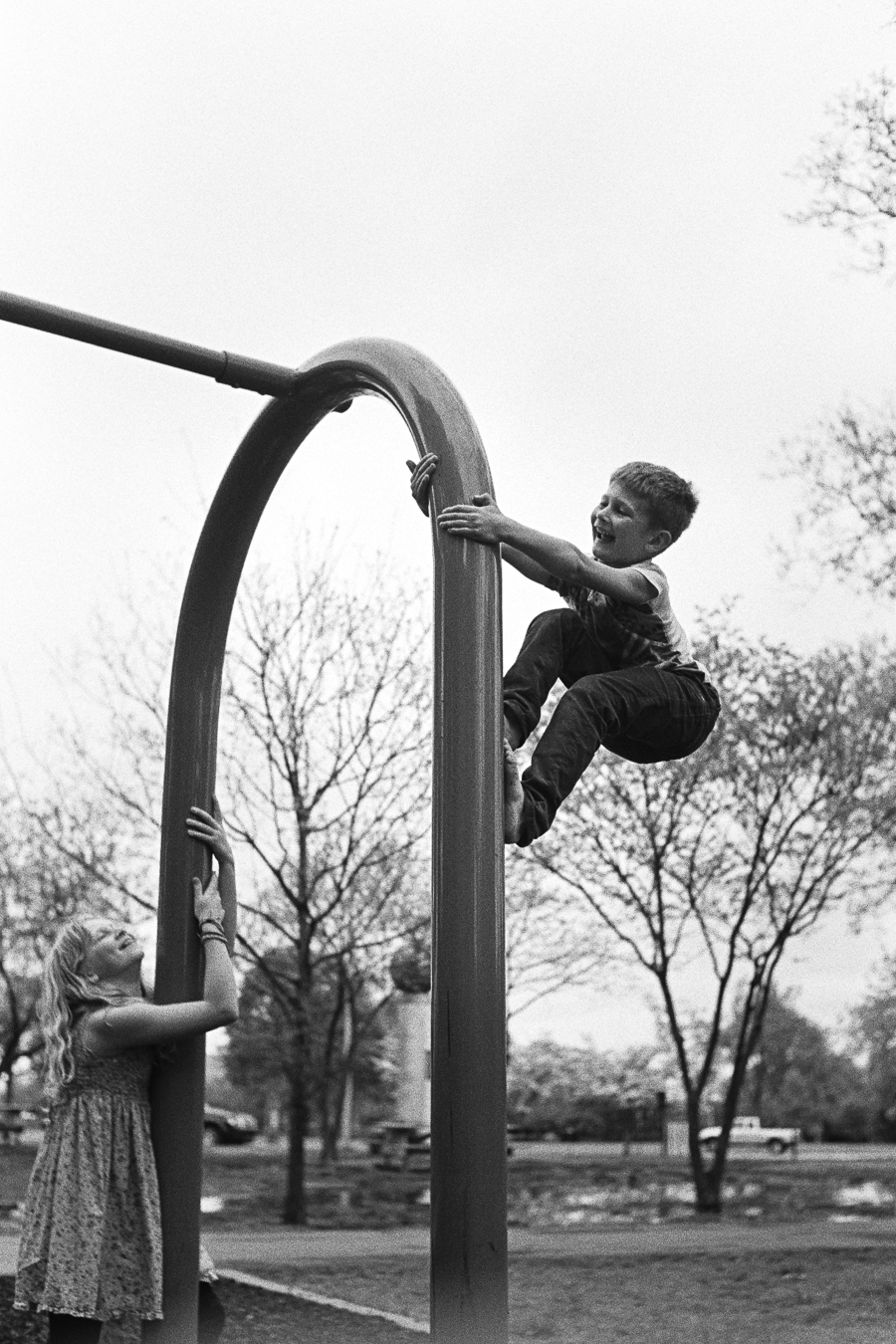 Jasper totally showing up Grace at barefoot climbing up a swingset...until he fell.