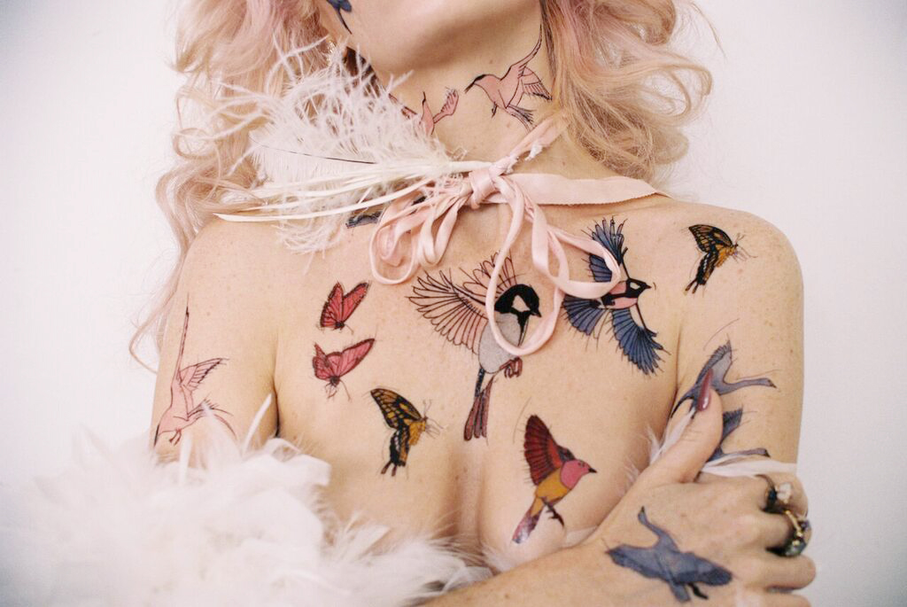 Audrey Kitching x Tattify / Illustration + Art Direction Ever since MySpace (whoa throwback), Audrey Kitching has been a style icon for me. Her edgy style, crazy colored hair and quirkiness are an inspiration to be different and not care what others think. I’m also an avid lover of birds and wildlife, so when we talked about her temporary tattoo collection and what she wanted… it was kind of a match made in heaven. I had the pleasure of illustrating these birds and butterflies for Audrey's collection, Lady of the Birds . Once the artwork was finalized, I put together a moodboard for the art direction of the shoot. Audrey and her PR representative, Erica, were amazing in organizing the shoot and getting a wonderful photographer by the name of Sean Scott to shoot it. After I received answers for the Q+A questions I sent to Audrey, I named and described all of the temporary tattoos based on the vibe of her answers. I created a newsletter and homepage website banners with a mix of the photographs from the shoot, and the illustrations I designed, giving it an overall etheral feel. Audrey is such a down to Earth person, making this collaboration super fun to work on! You can shop Audrey’s collection, Lady of the Birds, here . 2016