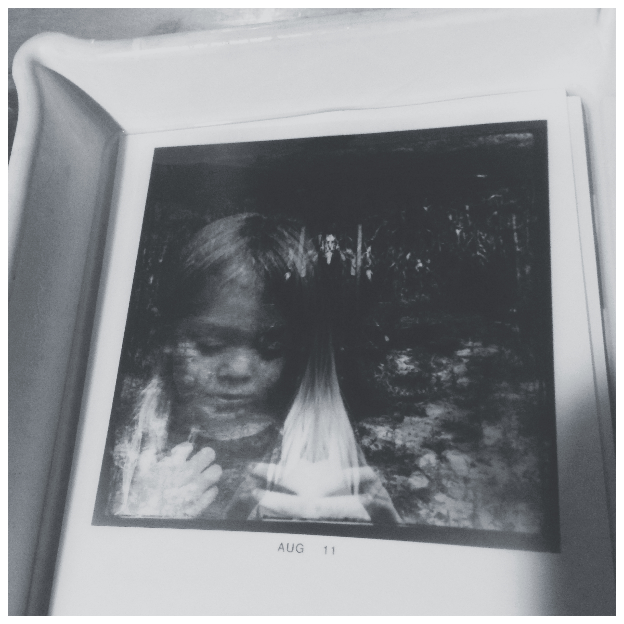  A week or so ago I received an email from my friend Marty and he said he had learned a new technique from another professor's student. Putting the iPhone in the Enlarger to make a print. I can say it worked pretty well but I chose a bad image because of the highlights in the hair. In my print his hair was blown out. I also made five or so prints before it occurred to me to flip the image. I downloaded the PS express app. and brought down the highlights and flipped the image so that it wasn't backward. After all this I still didn't make a perfect print but I learned a lot. I would suggest a print smaller than 8x10 because I can barely see the dots at that size. For anyone who wants to try it. First, on the iPhone go to settings General, Accessibility, and switch Invert colors to on, which will make everything on your phone a negative image. I also went into the Settings wallpaper and brightness and turned the brightness all the way up. You may also need to go under General, and change the Auto-lock to never so the screen doesn't go black while you are printing an image. Next, Go into the photos and pick and image to print. Stick it in the enlarger (I made a cardboard carrier to so my iPhone didn't get scratched). Open up your Aperture to 2.8. I used a grain focuser to focus and you see small color rectangles which makes it easy to focus. You also need a lens cap to control your exposure. I used a Holga lens-cap. I unplugged the timer on my enlarger because I wanted to flip the switch and flood the paper with light. I used a manual timer instead.. Finally you should be ready to make a print. Thanks MC.