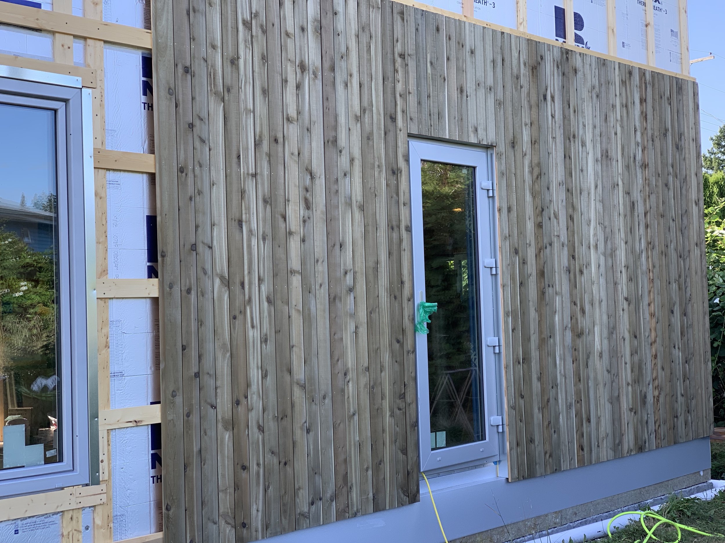 Vertical siding over rainscreen