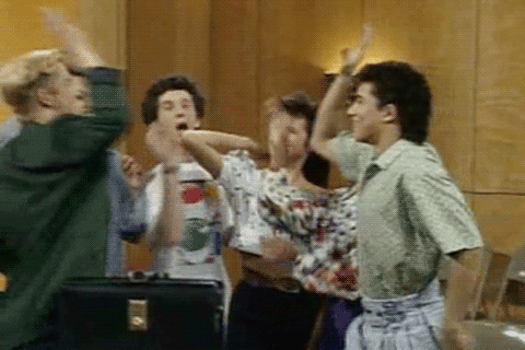 An animated GIF of the cast of Saved By the Bell where 6 people are doing a high-five together.