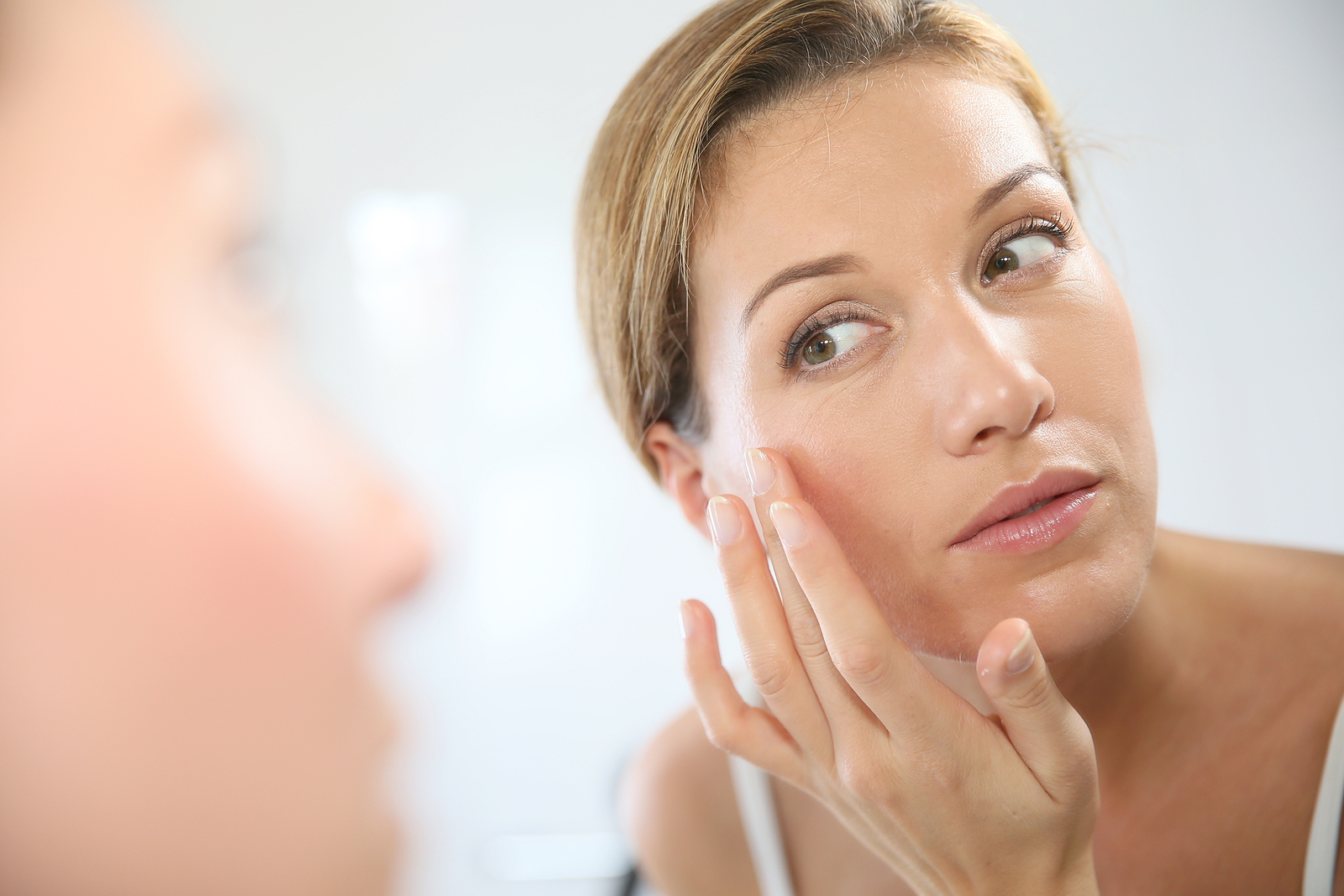 Middle-aged woman applying anti-aging cream