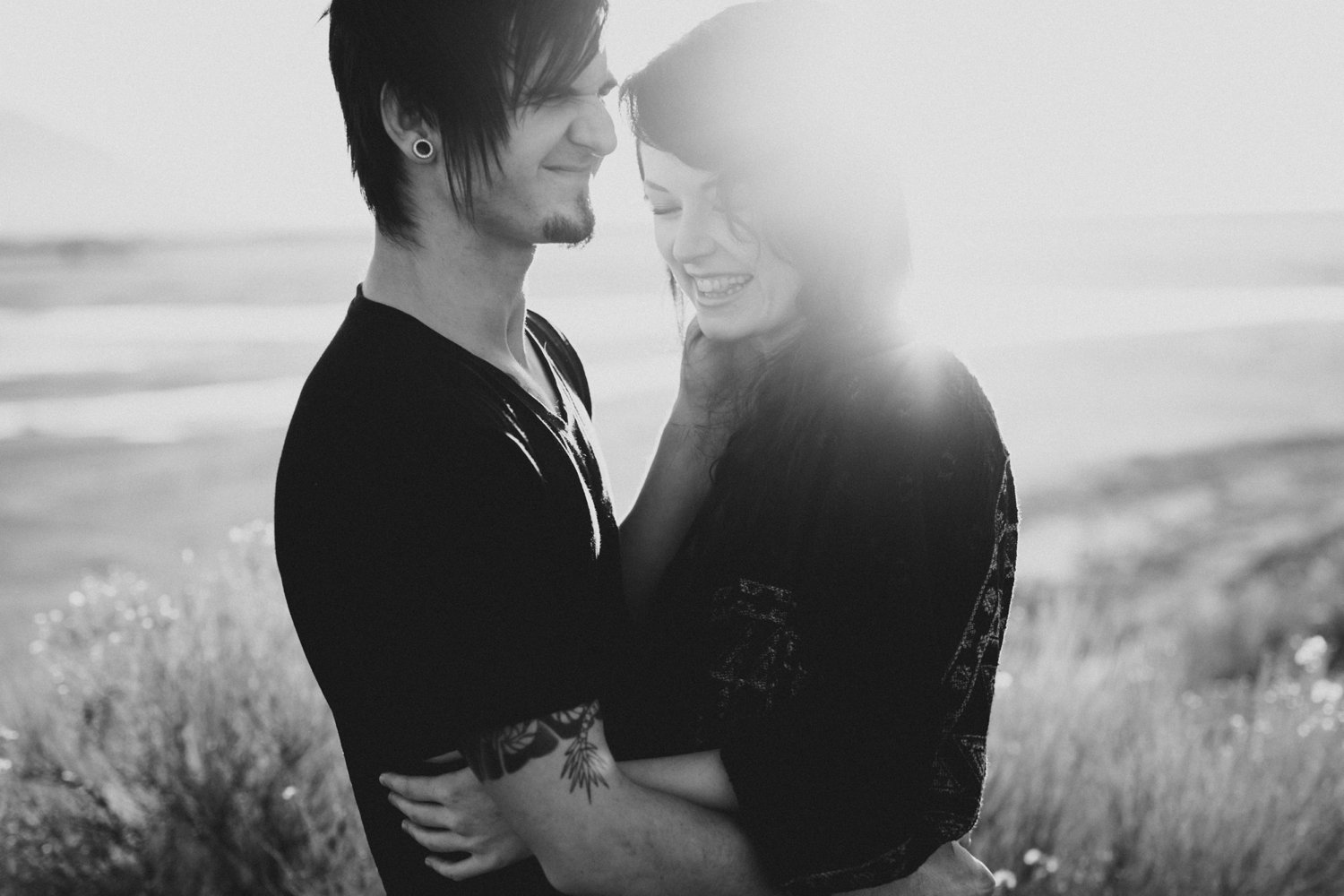 Black and white photo of a couple laughing by photographer Catalina Jean