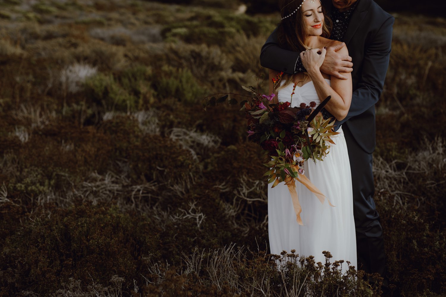 A candid photo of a bride and groom during their post wedding photo shoot.