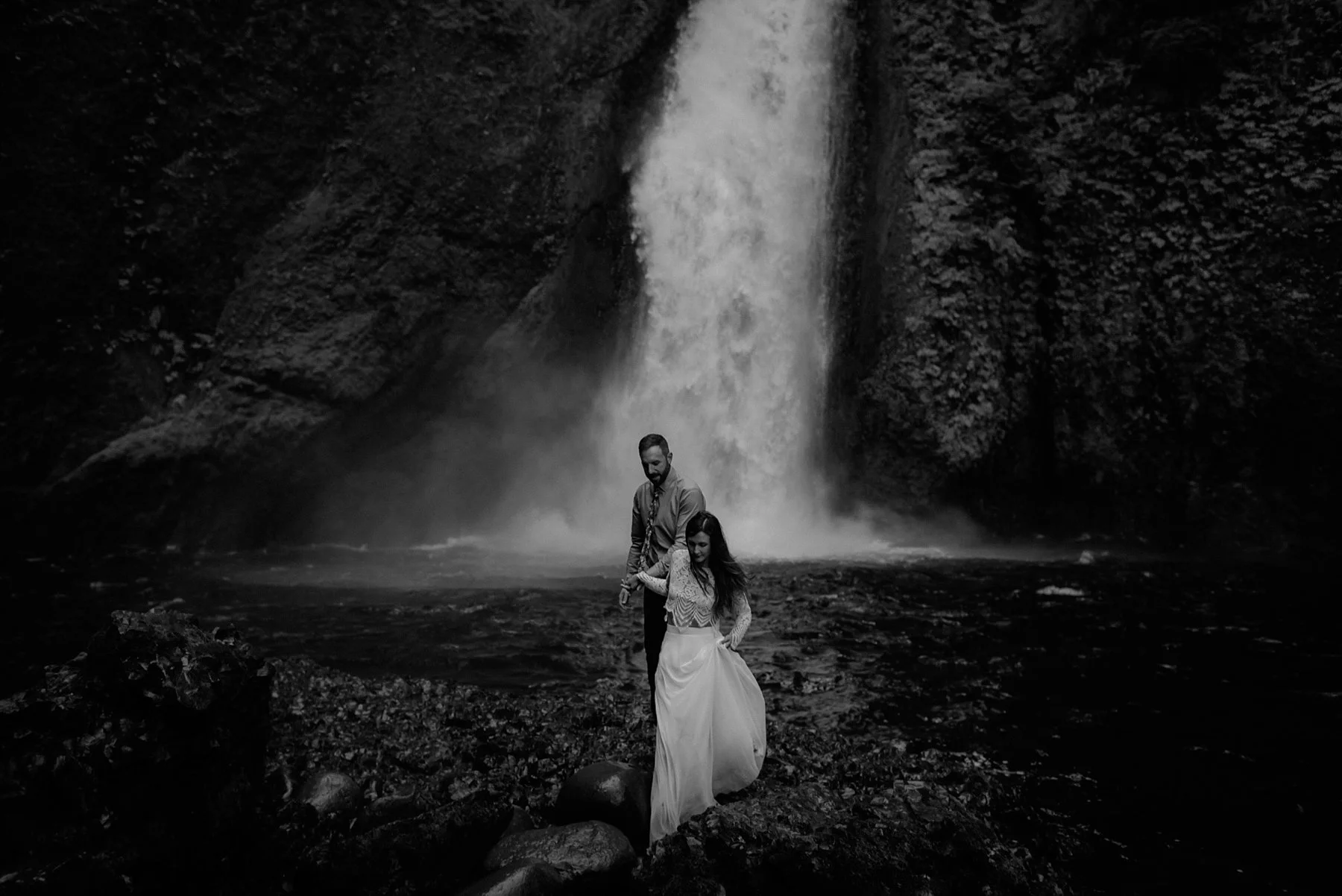 A bride and groom below Wahclella Falls at their elopement wedding by Portland photographer Catalina Jean