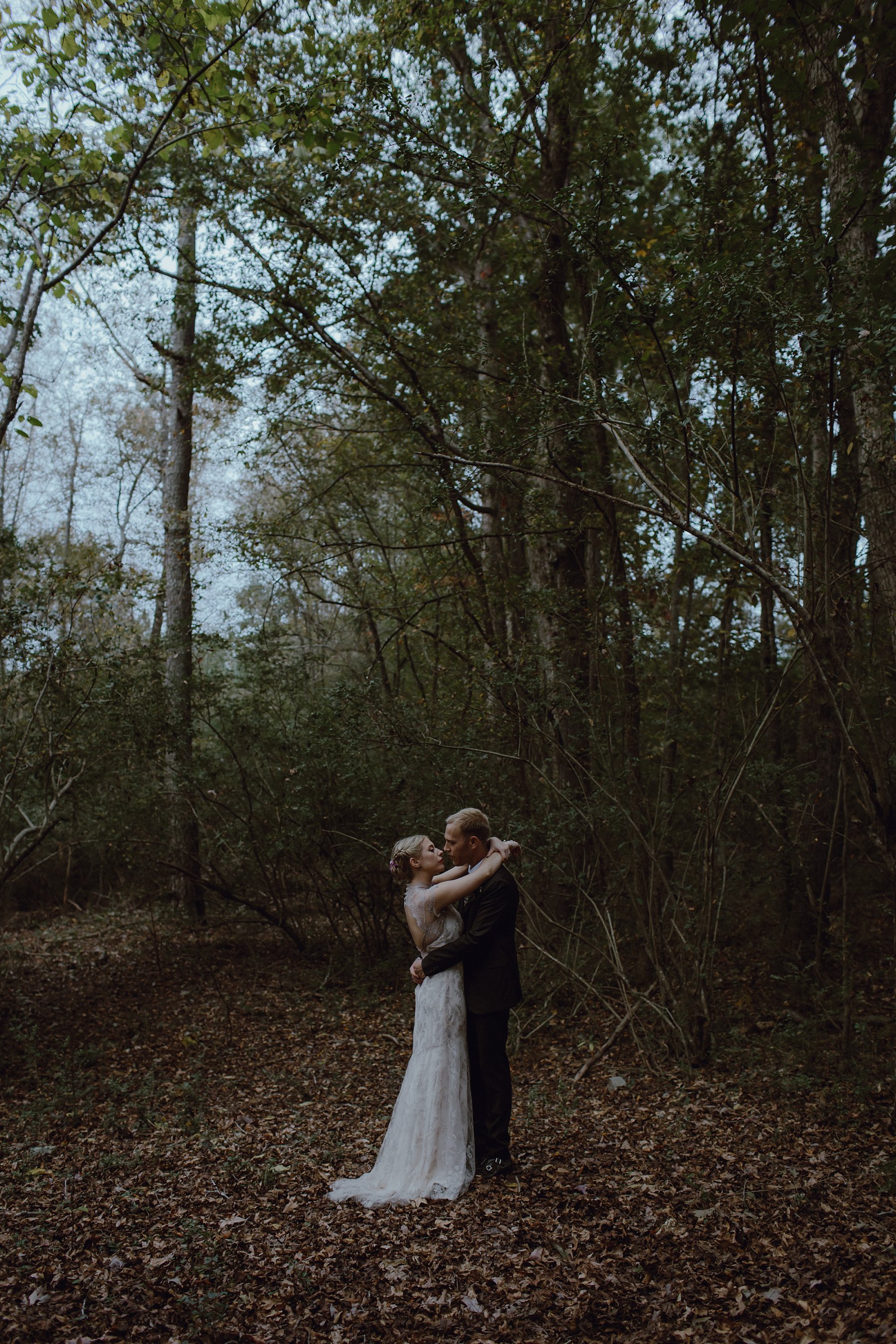 A forest photo of a bride and groom by Catalina Jean Photography