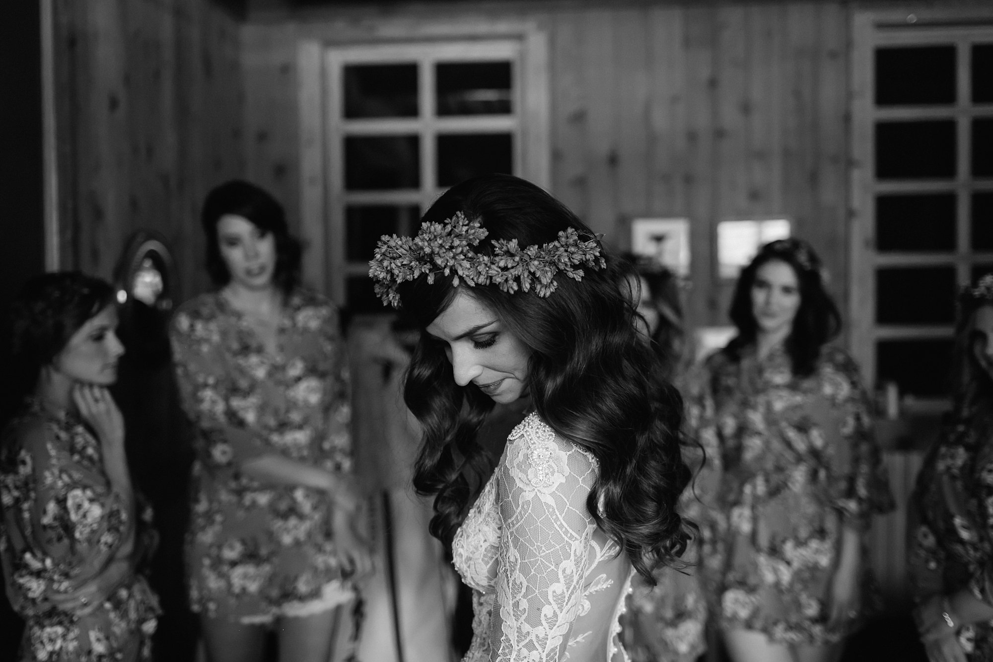 A bride puts on her dress at Ten Mile Station by Catalina Jean Photography