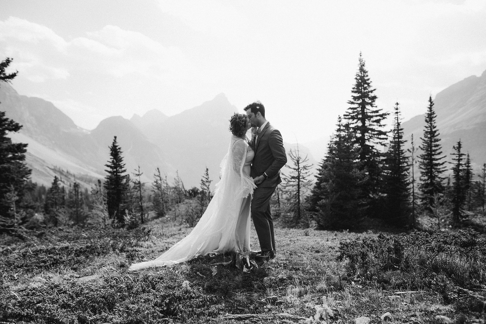 A bride and groom's first kiss in Banff