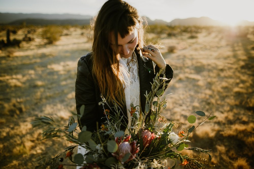 The bride in a motorcycle jacket and a wild boho wedding bouquet