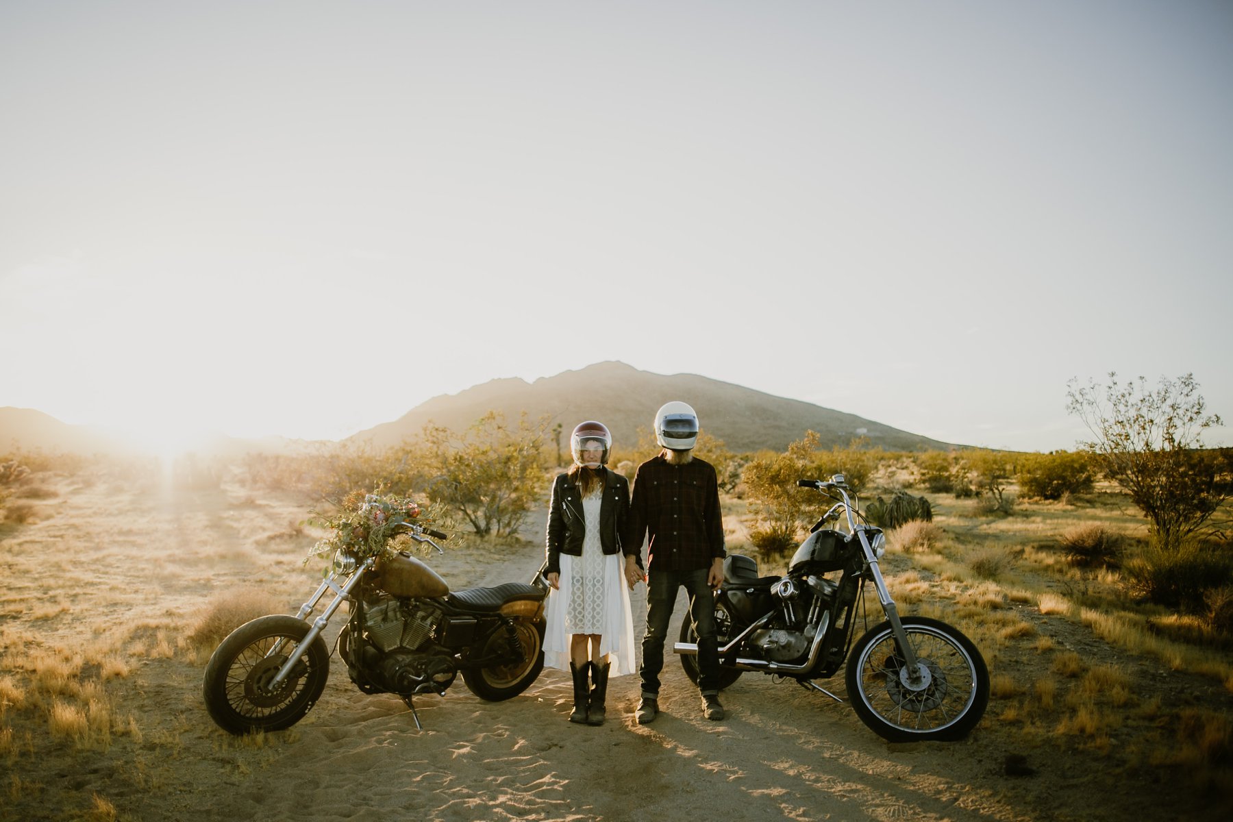 The bride and groom with their motorcycles at their motorcycle elopement