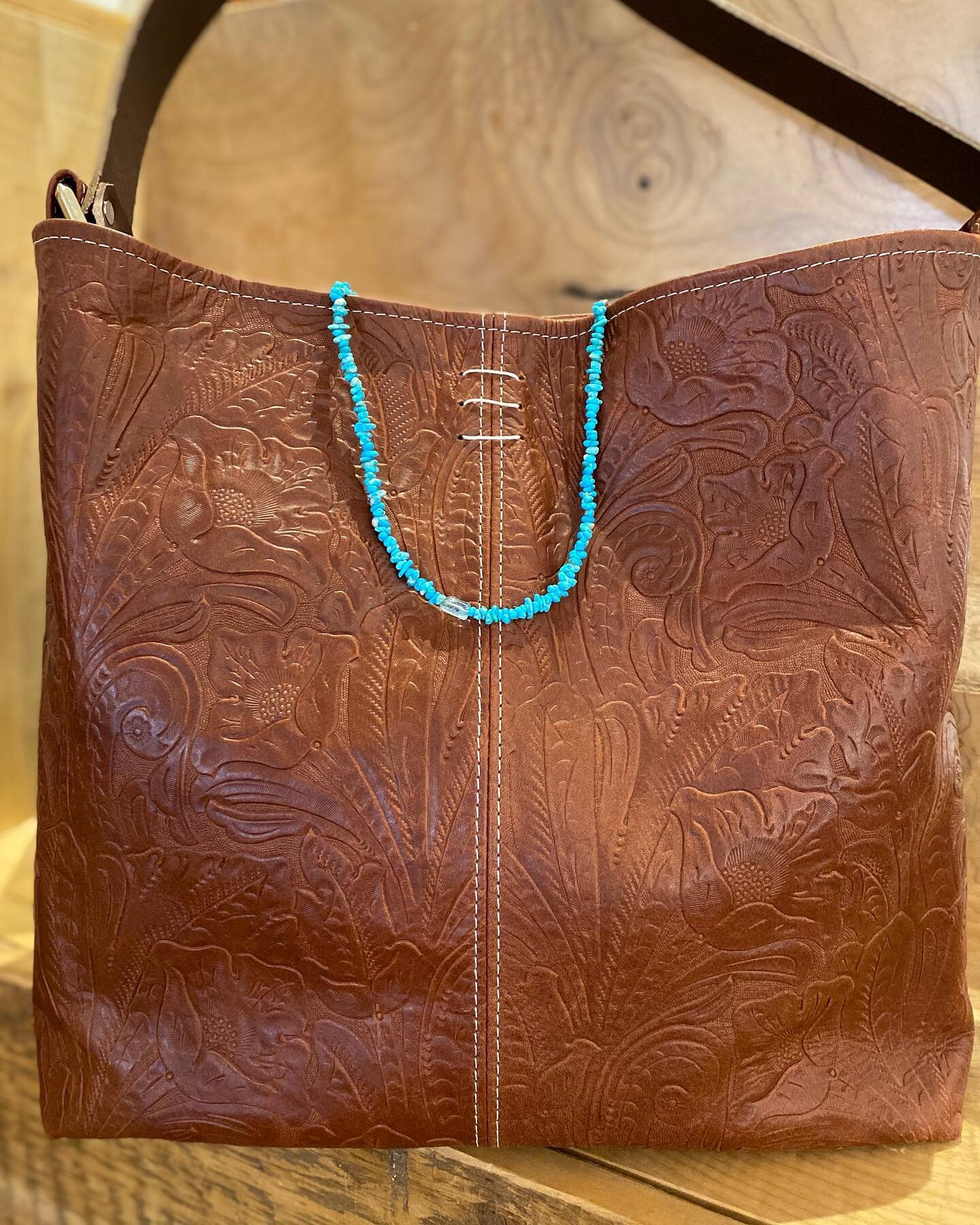 A big beautiful #cinder bag with @buchanjewelry turquoise necklace draped over the collar.  I love brown and turquoise together! @riversidestudios