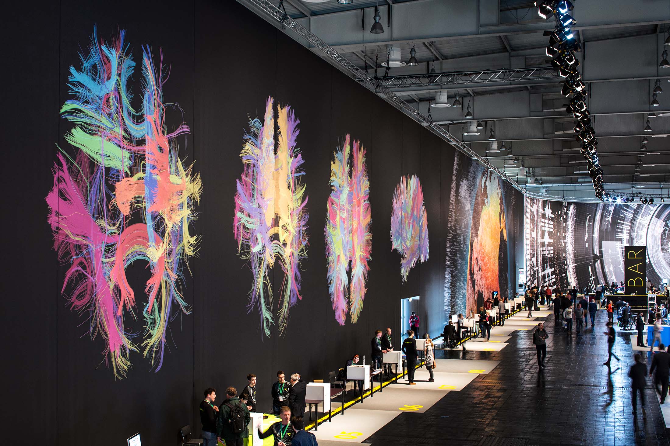 Contemporary data-driven innovation is represented and visualised as a massive repository of human culture and activity, able to tackle and articulate the complexity, breadth and depth of the information available within virtual spaces. A 3.000 square meter, floor-to-ceiling terapixel graphic makes manifest the largesse of Big Data, the theme of this year's CODE_n. The designers imagine systems beyond human perception and use custom code to plot massive amounts of data on spectacular canvases.
