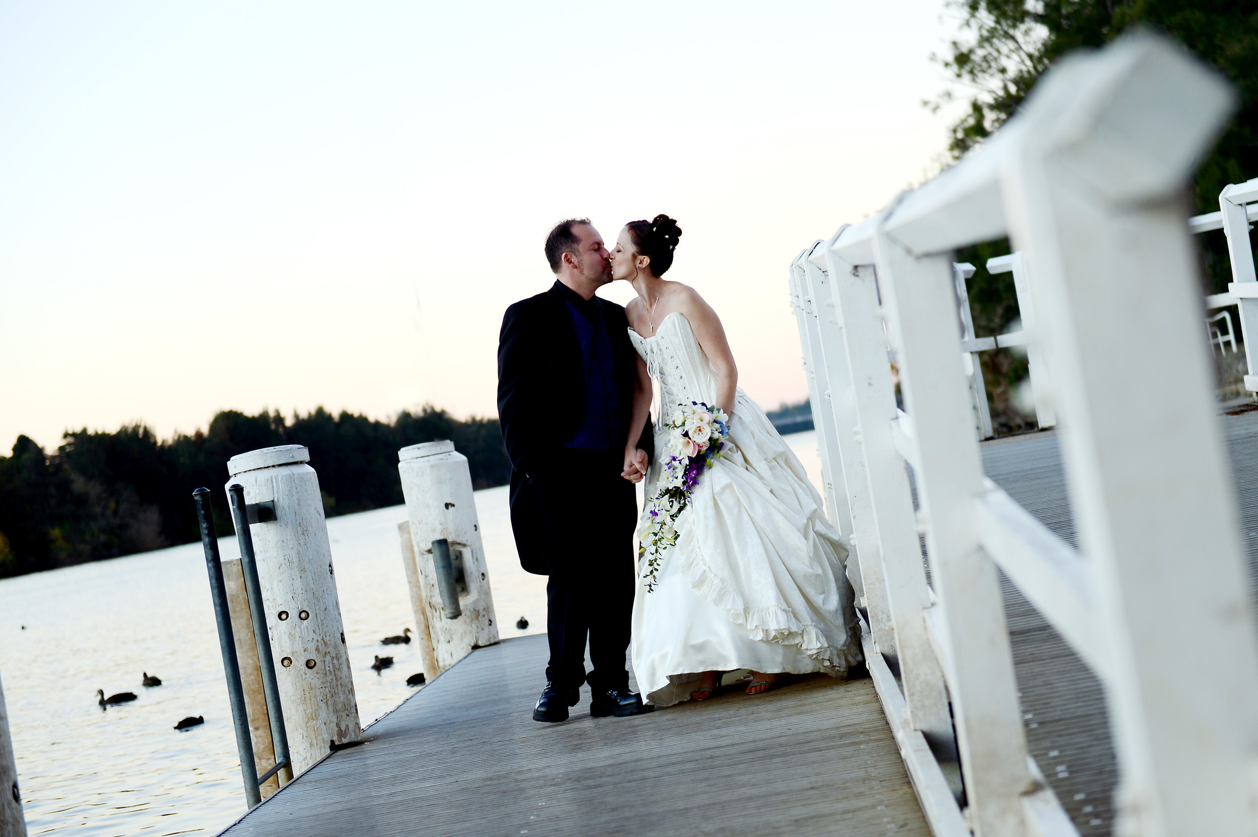 Belle wedding bride groom kiss wharf jetty river.JPG