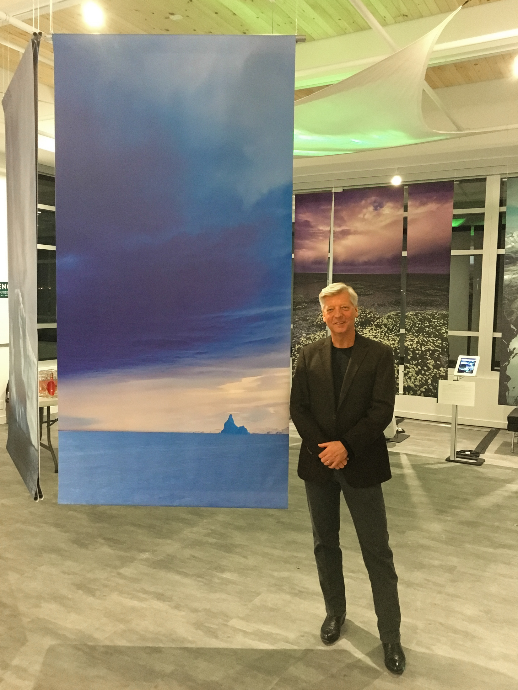 Stephen Gorman next to one of his photographs in the exhibition.