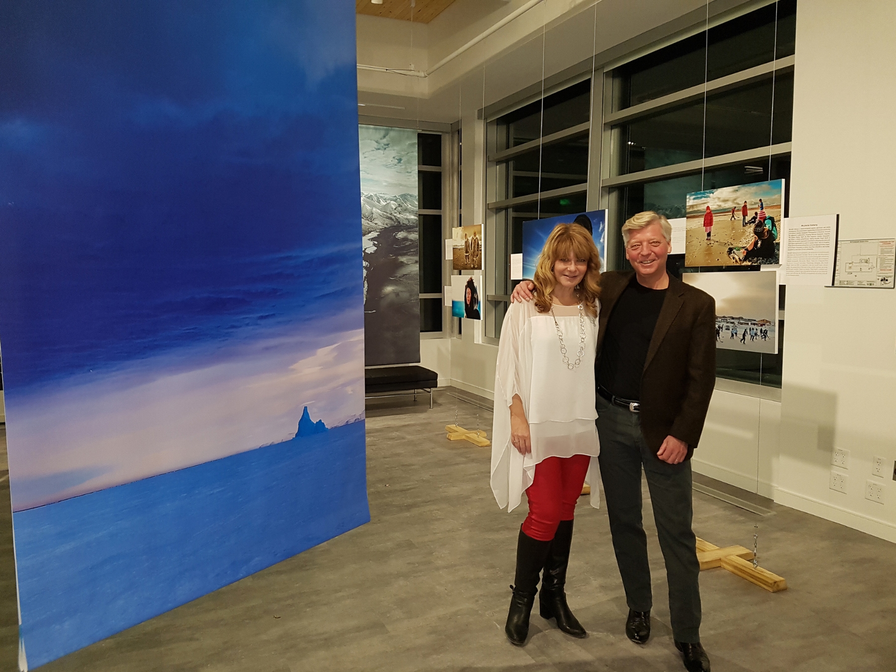 Canadian Arctic photographer Michelle Valberg and American Arctic photographer Stephen Gorman in front of some of Michelle's and Stephen's photographs. 
