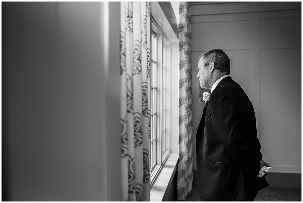 black and white photo of dad waiting for daddy daughter first look 