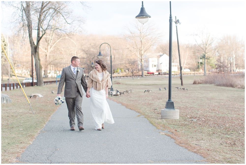 bride and groom walking winter wedding at rockaway park new jersey