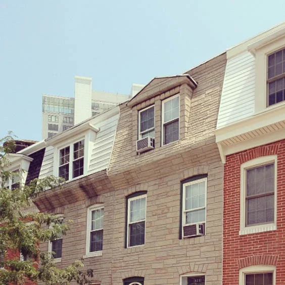 Form stone clad dormer window and mansard roof