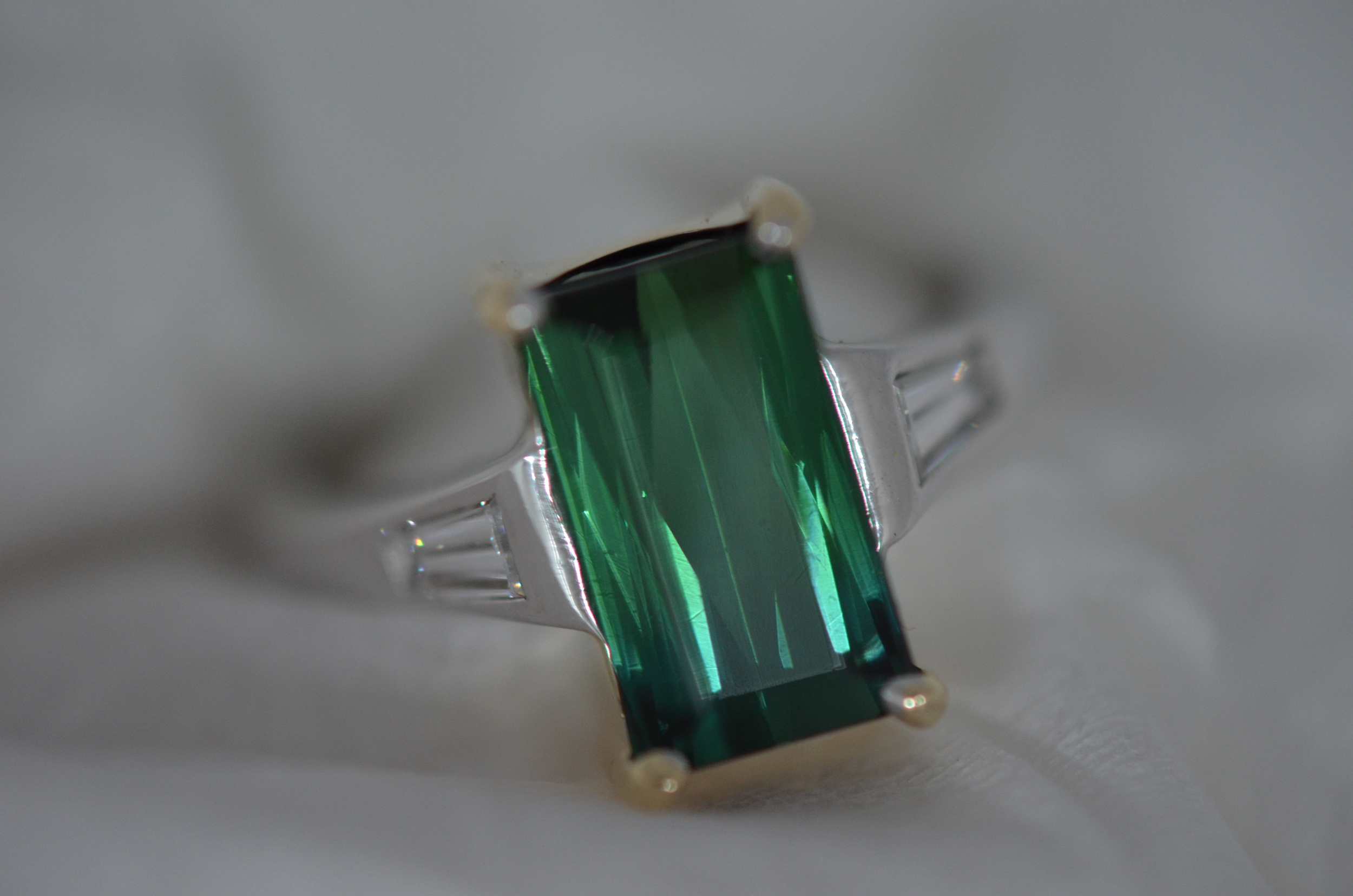 Custom-made green Tourmaline ring with tapered baguette diamonds.