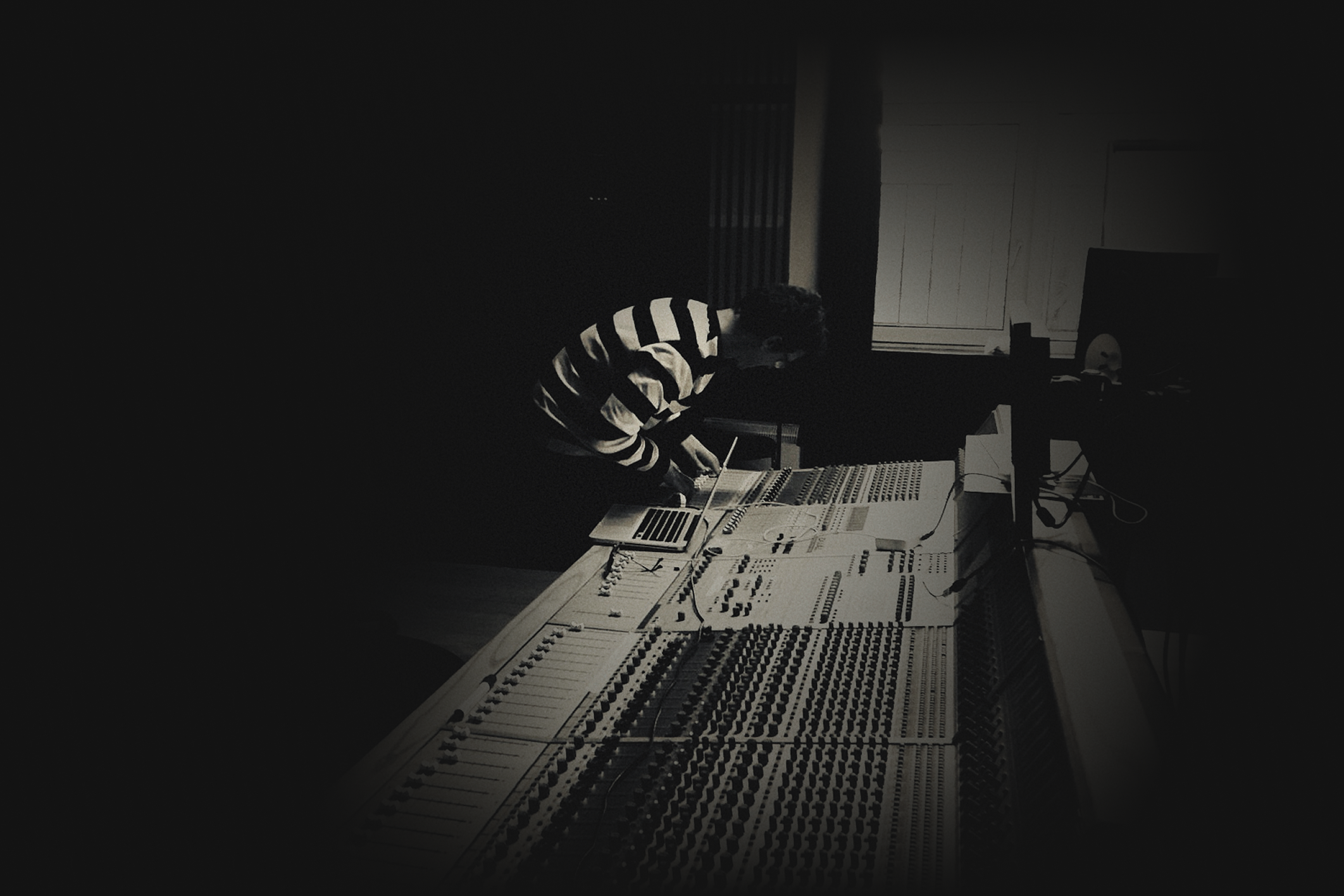 Ciaran O'Shea in a studio with a large format console