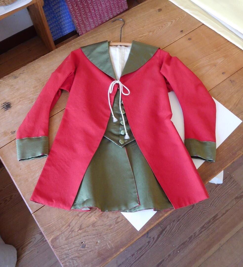 Oh, the joys of Colonial Williamsburg! This was hanging in the Tailor Shop when I stopped by. Alert readers will notice the resemblance between this lady's riding coat and waistcoat with the attire of the lady in my recently posted image, &quot;The J