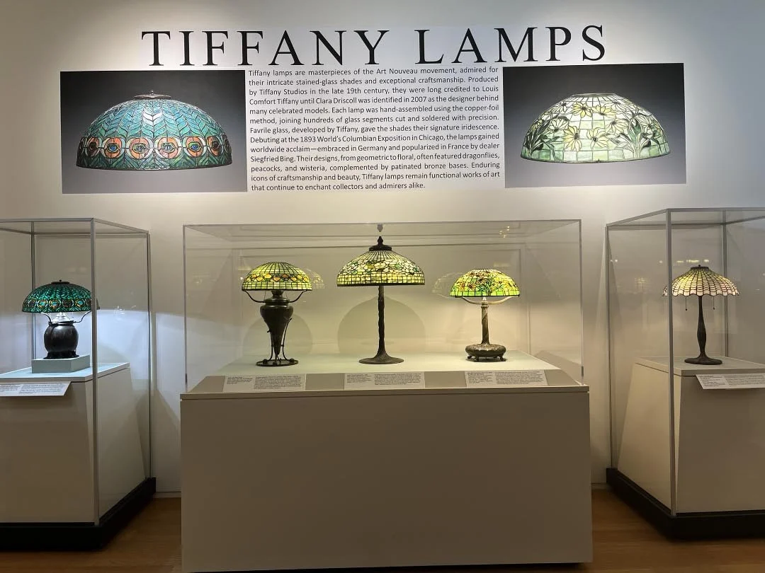 The image shows five different Tiffany lamps