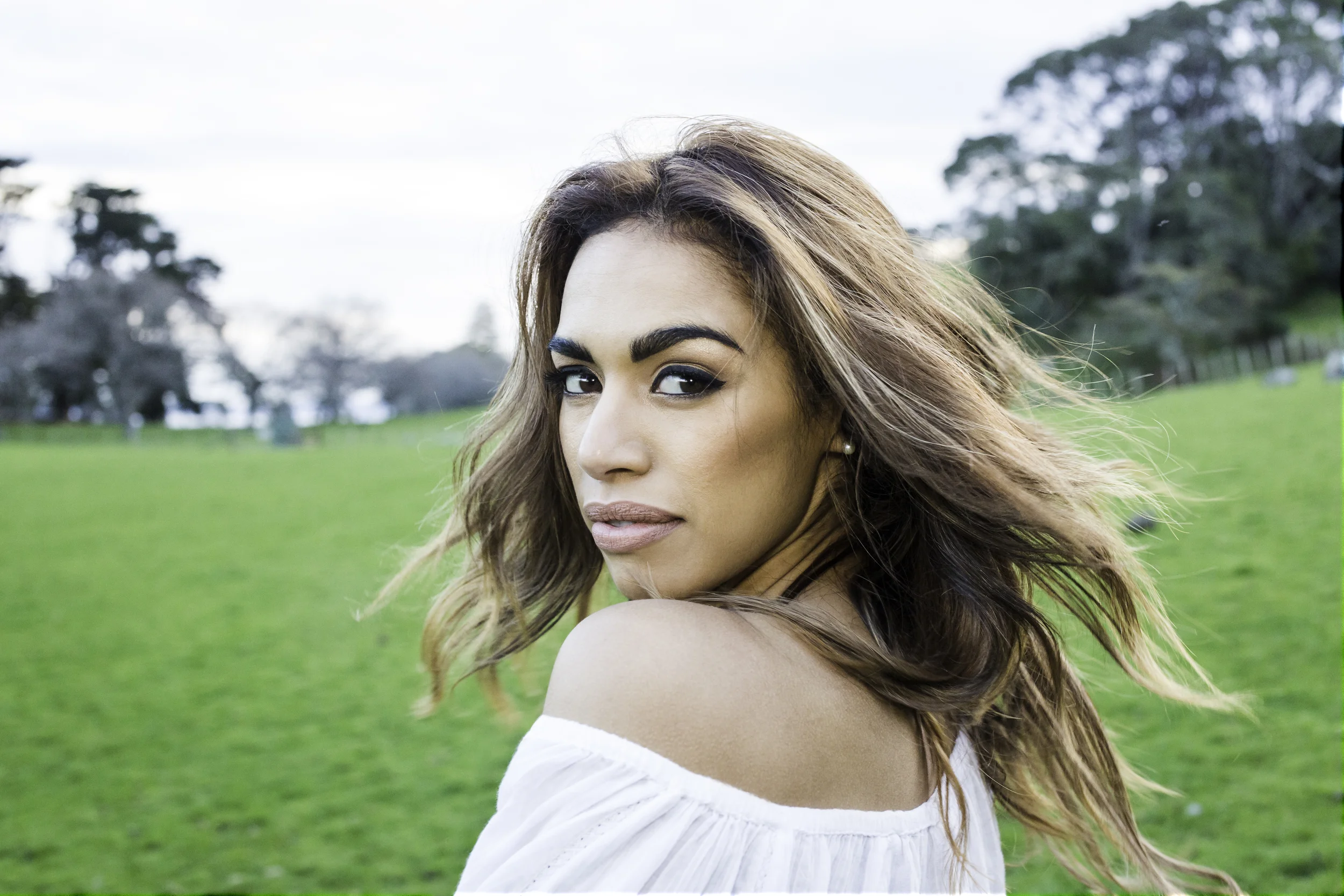 The bulk of editing has been done here. A few things I've done: It has been brightened, I have changed her top slightly and smoothed skin tonal changes as well as adding highlights and darkened parts of the image to make the face and hair stand out from the image.