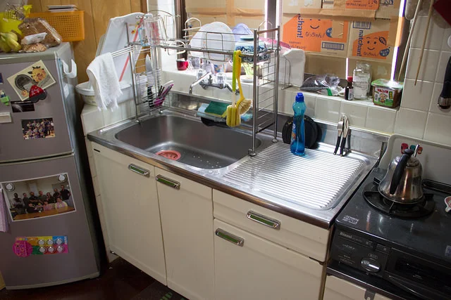 Sink/dishwashing area, and fridge.
