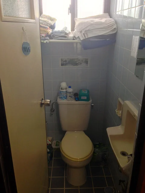 The toilet bathroom. Contains a super tiny sink and some tension rods we use for our linens. CLASSY!!