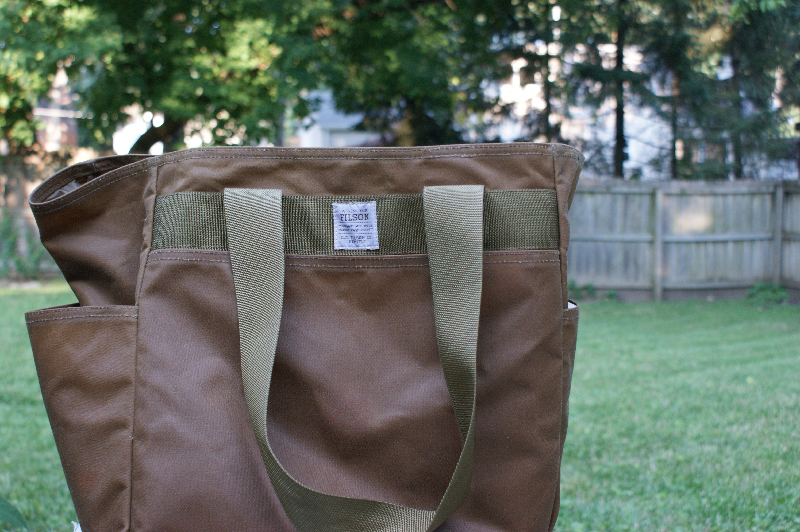 This man bag holds everything. There's sunscreen, bug spray, two towels, a bathing suit, 2 books and 5 magazines in there. I think we actually own 3 of these. 