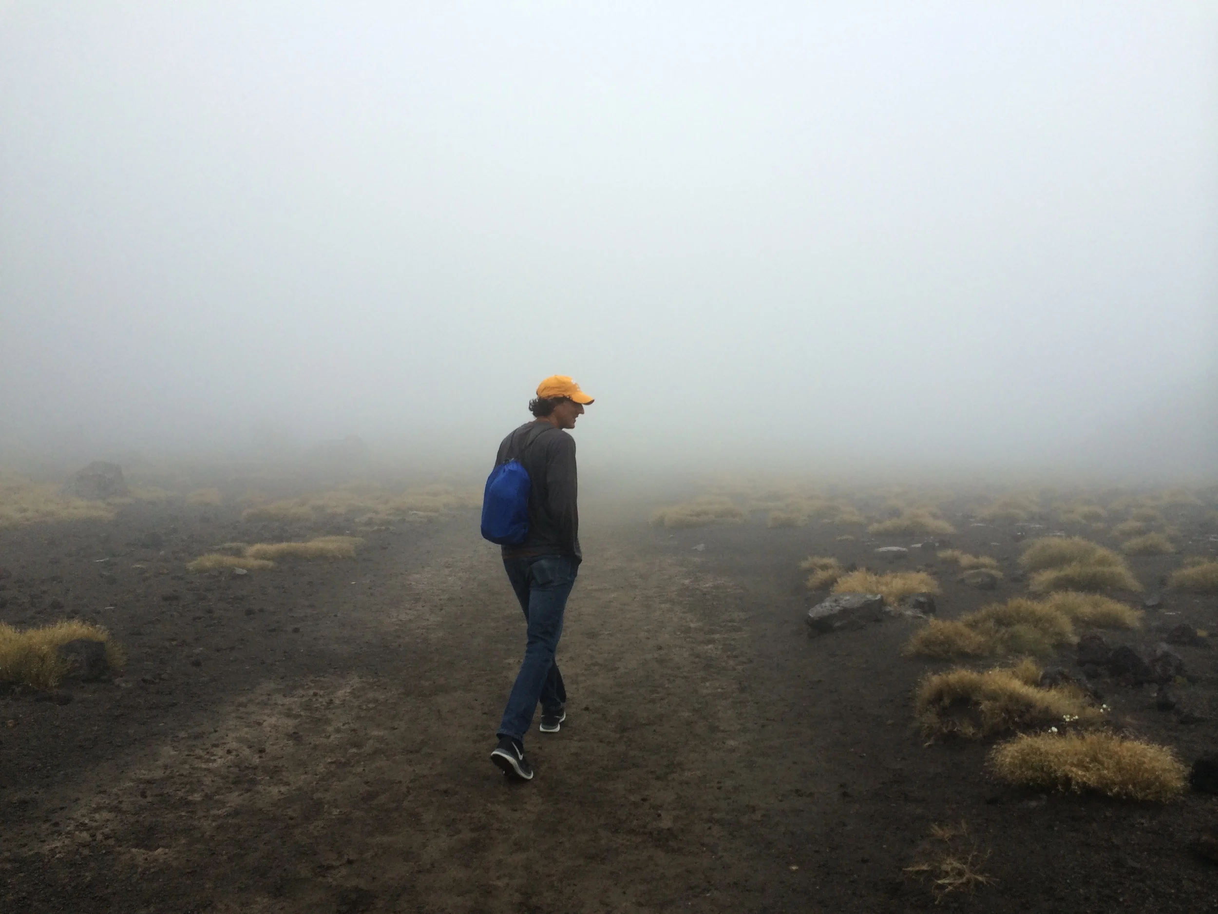 alex hiking into the mist.