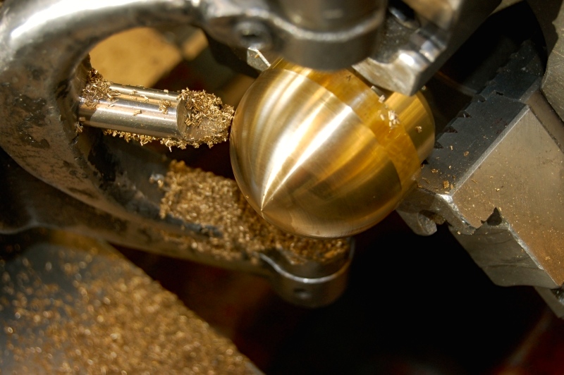 Brass cap before cold pressing it into vertical aluminum tube.