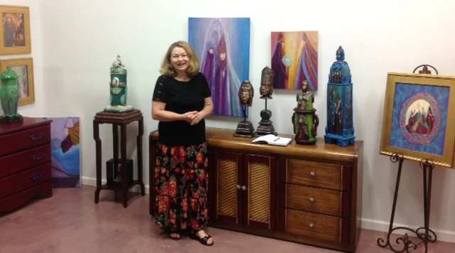 Visionary Art from Heart and Soul TheArtWorks™, located at 200 Willard St.is featuring a resident artist for September, Erika Lawrence , with her “Visionary Art from the Heart and Soul” collection of oils and hand built sculptures on September 26th during the 4th Friday Gallery Walk in downtown Wilmington. A Reception, open to the public, will be held on September 26th from 6pm to 9:00pm at theArtWorks™ with live entertainment by Susan Savia during the evening. Erika Lawrence was born in Hungary and immigrated to the United States with her family as a refugee during the Hungarian Revolution. She has been painting and sharing her creative talent for close to 40 years. In the last 17 years she has evolved as an artists and now considers herself as a “Visionary Artist”. In her studio back in Western New York, she was experimenting with trying a new technique in painting when she suddenly realized that she was starting to see faces emerge on her canvas even though there was only a mixture of several colors on the canvas at that time. The faces where American Indians with elaborate headdresses. Even though she was startled by this experience she remained curious enough to continue and finish a painting with these images on them. Later she discovered that her newly built home was, in fact, on an old Indian trail and possibly an old Indian burial ground. She soon came to the realization, as faces continued to appear on her canvas, she was able see beyond what most people would call normal. Struggling with this new found gift and visions on a canvas, she kept it to herself thinking that people could misunderstand and perceive her as being odd. She chose not to reveal the nature of her paintings and how it all started until now, sharing her original experience for the first time with the public. Erika trusts her inner guidance as her source and force as she continues to use the original technique and process of painting she discovered many years ago to create her art work today. Erika, calls her faces “icons”, and upon seeing her work one would also think that her artwork has also been influenced from her eastern European heritage. Her art is vibrant in color and has spiritual connotations with such titles as “Transformation”, “Guardians” and “Together As One”. Her unique paintings are done in oils and she believes that the icons in her creations, which she also refers to as “Spirit Guides”, are meant for someone special. In the last 3years, she has started to expend her talent into working with clay and hand building sculptures. Her sculptures include vessels with carvings of icons or 3D icons emerging, sculpture of a 2 ft. icon with an ancient “tree of life” symbol for her crown as she is kneeling holding the world in her hand and an icon holding a bird riding an elephant. A recipient of several awards for her creations throughout the year she maintains that the greatest honor for her is when someone really connects and falls in love with one of her creations. Her desire and ultimate goal with her creations is to “Capture the eye, delve into the essence of the mind, uplift the spirit and stir the heart of others”. Erika Lawrence has had her work in several galleries in Western New York, Raleigh, Southport, and Wilmington. Currently all her paintings and sculptures can only be seen at theArtWorks™ where she is now a resident artist maintaining her own working art studio and personal gallery space. Erika can be found working most days in her studio and is happy to meet clients anytime in her studio by appointment by calling her at 910.792.9378 or when theArtWorkstm is open to the public. In the process of becoming an Art Village, theArtWorks™ is also available for events, workshops and much more. It is located in an area known as the Cape Fear Historic Byway and currently theArtWorks™ is only open to the public on 4th Fridays (Wilmington Gallery Walk) and every Saturday from 10:00am to 3:00pm when residents artists open their studios to the general public. For more information about theArtWorks™ call 910.352.7077. For more information contact: Erika Lawrence Erika7law@aol.com 