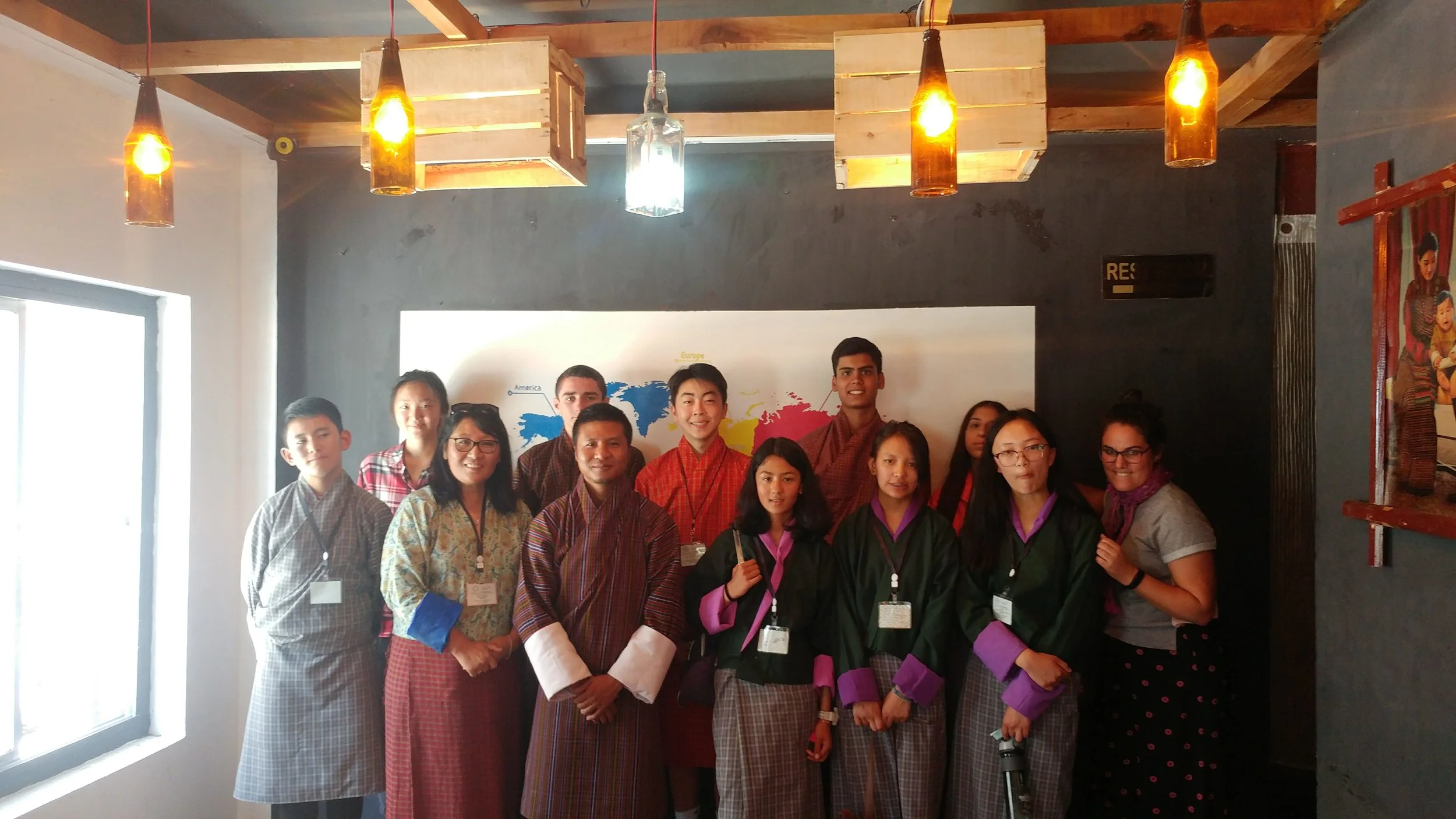 The "Media" group learns about public television from popular travelogue show host, Sangye Choiphel (third from left, front row), at the hip "Café Incomplete" in downtown Thimphu. His show, Nazhoen Express, educates Bhutanese about the rich culture of their own country and has given people from around Bhutan a sense of pride about their small villages and distinctive cultural practices. (Mme Deki, ELC Principal extraordinaire, second from left!) (Students, from L to R: Sonam, Skylar, Alex, David, Samara, Ishaan, Kunchok, Miraya, Choiying; plus Ms. Staffaroni!)