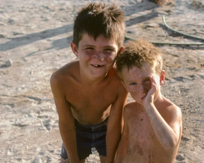 Gene's boys were tough, with bodies that were getting weathered. No shoes. No sunscreen. Like their dad. 
