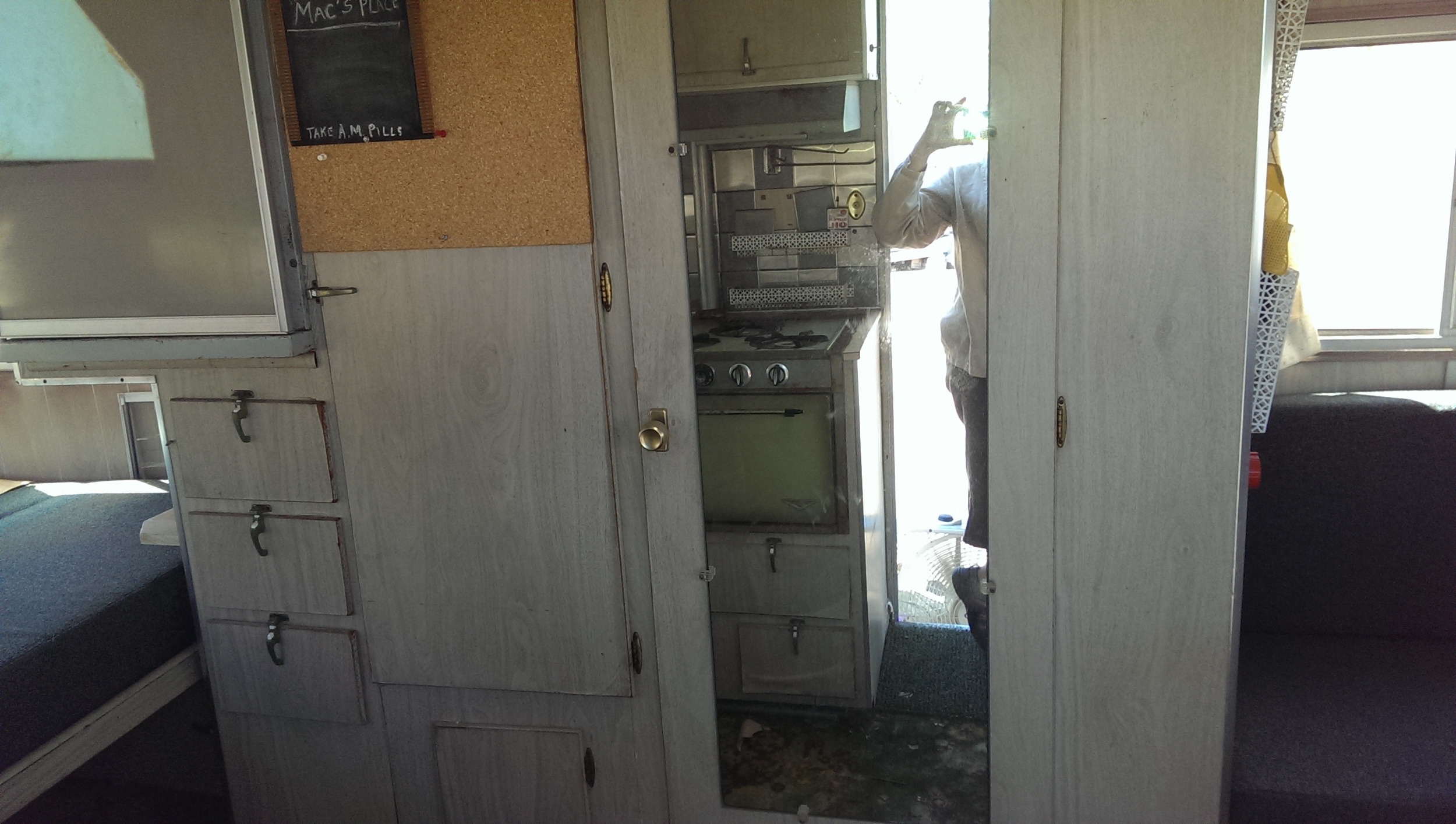 Straight in the front door; behind the mirror there is a toilet. 