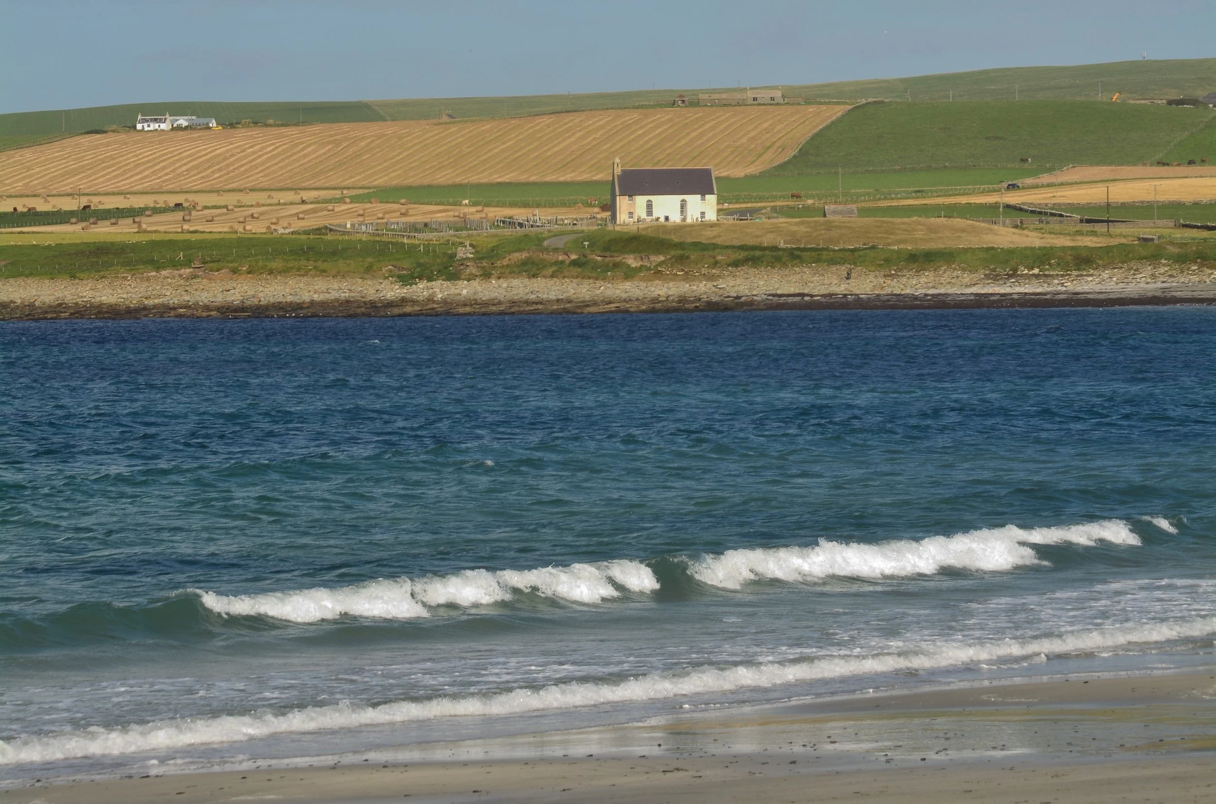 A kirkyard across the Bay of Skaill from Skara Brae on Orkney Island