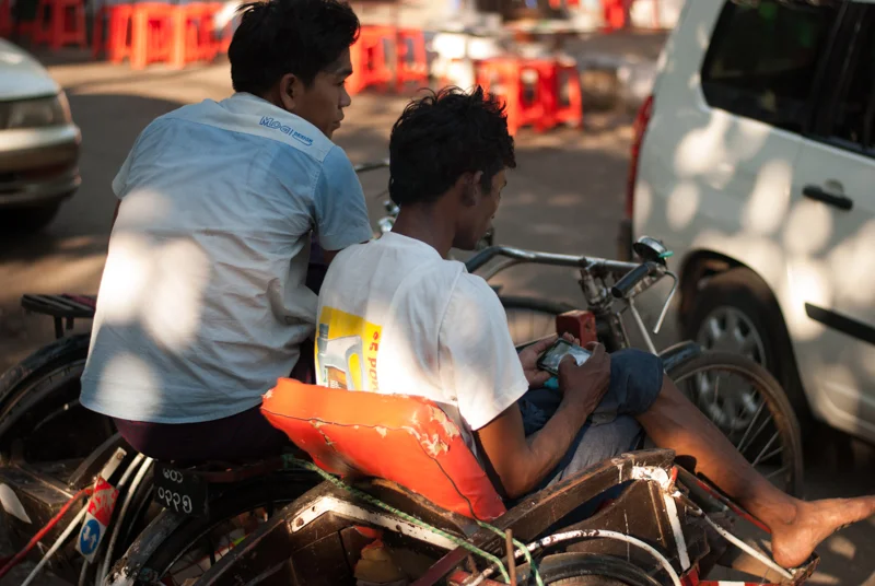 A man and his smartphone in the streets of Yangon