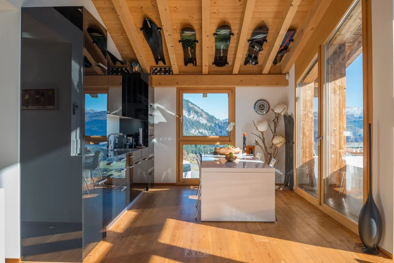Even the kitchen is overlooked by the extensive snowboard collection