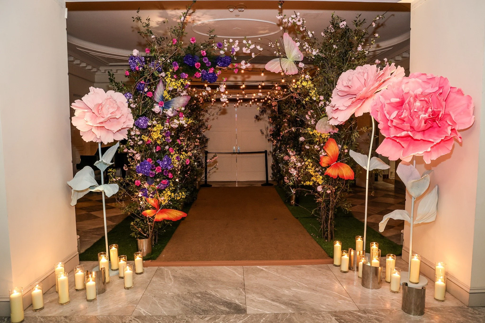 A garden entrance in full bloom&mdash;oversized florals and a trellis leading the way with a touch of whimsy. 🌸✨
